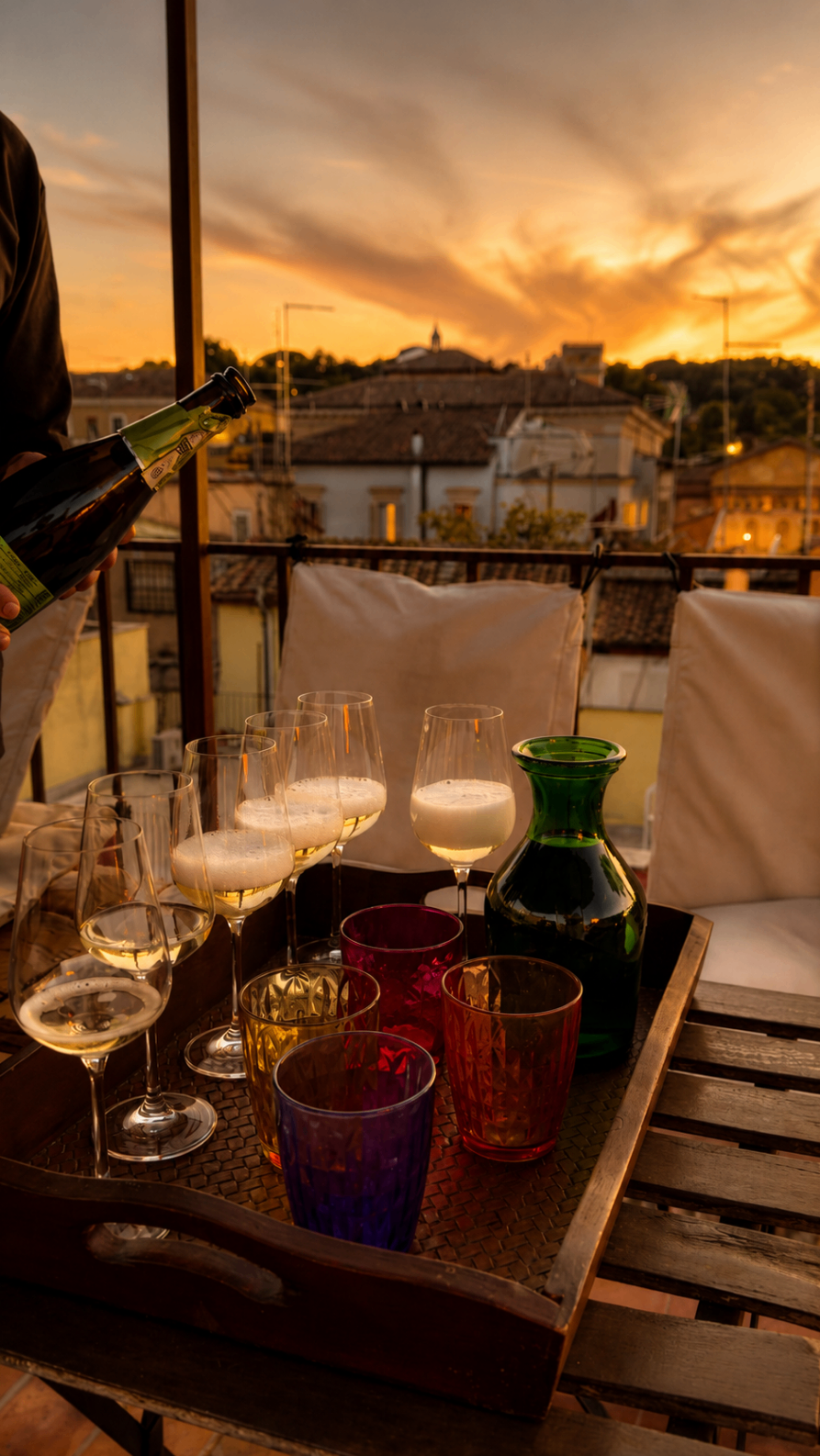 Wine glasses on a rooftop at sunset